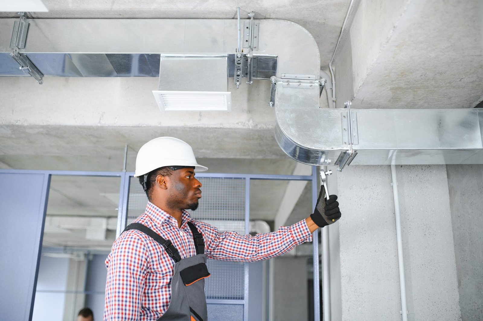 hvac worker install ducted pipe system for ventilation and air conditioning. copy space