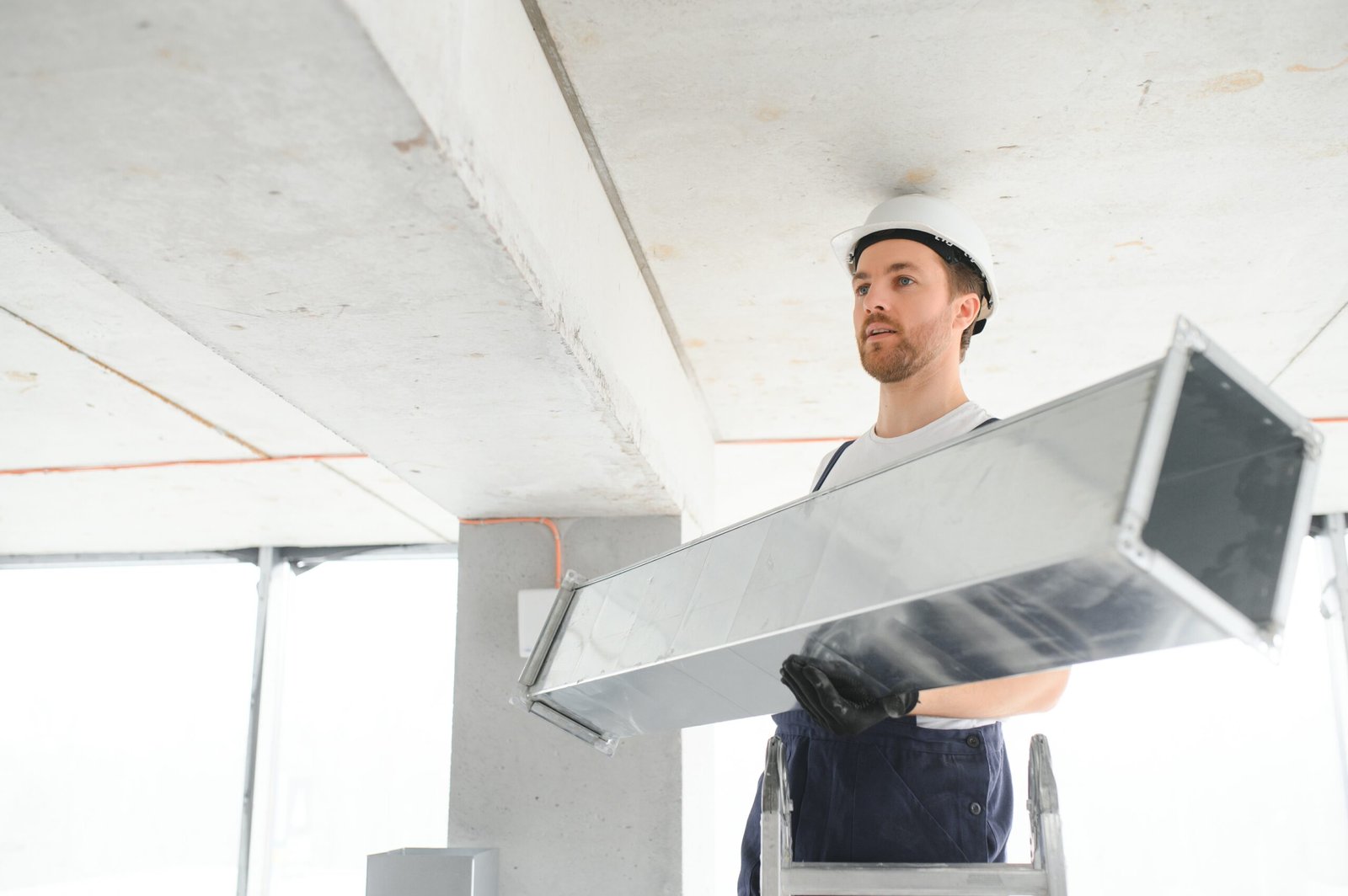 hvac services - worker install ducted pipe system for ventilation and air conditioning in house